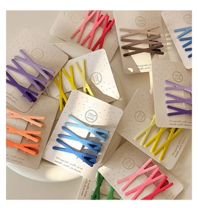 Detail of candy-colored matte cross hair clips in various pastel shades on cards