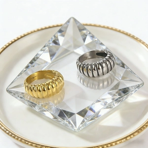 Macro detail of gold and silver textured croissant rings with spiral engraving patterns