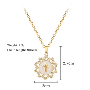 Detail of gold star cross necklace with zircon stones, shell inlay and 4.3g weight