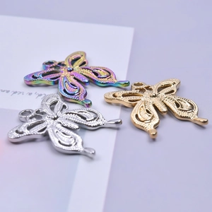 Detailed view of hollow butterfly charms in iridescent, silver, and 18k gold finishes