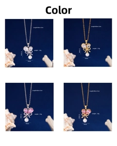 Detail view of heart butterfly pearl necklaces in silver and gold with pink zircon
