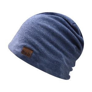Close-up of dark blue beanie showing fine blend texture and brown leather F & S label