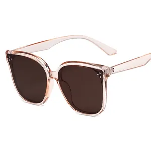Stylish square pink transparent sunglasses with dark brown lenses and metal rivet accents