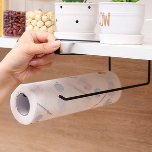 Black metal under-cabinet paper towel holder hanging on a white shelf in a kitchen