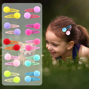 Detail of colorful plush ball hair clips set for girls and model wearing style