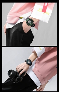 Close-up of black digital outdoor sports watch with vibrant green and blue accents