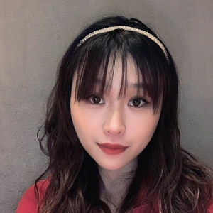 Elegant thin gold headband with crystals on an Asian model with long brown curly hair