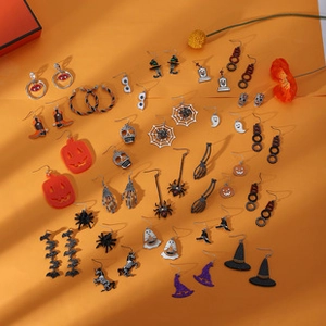 Detailed collection of Halloween earrings with pumpkin, ghost and bat motifs on orange background