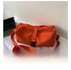 Size comparison of orange Oxford fabric crossbody gym bag with a smartphone and laptop