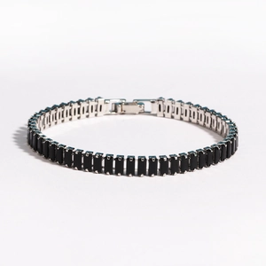 Close-up of black rectangular zircon stones set in a polished silver chain bracelet