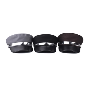 Flat top military caps in grey, black, and brown with leather brim and silver metal trim
