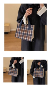 Detail shot of brown and blue checkered canvas tote bag with sturdy blue handles