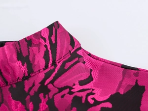 Close-up of pink and black floral jacquard fabric with elegant bubble sleeve details
