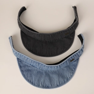 Detail of dark grey and light blue denim sun visors with metal logo and curved brims