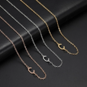 Detailed macro shot of 304 stainless steel 'C' letter necklaces in rose gold, silver, and gold