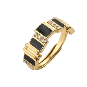 Macro detail of 18K gold-plated open ring with black enamel blocks and zircon stones