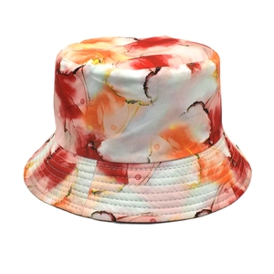 Detail of vibrant red and orange watercolor floral print on lightweight fabric bucket hat