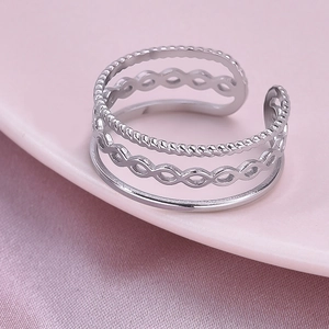 Macro view of silver multi-layered 304 stainless steel ring with twisted and smooth bands