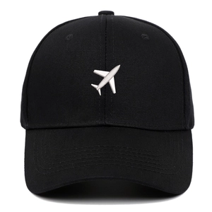 Black cotton baseball cap featuring white airplane embroidery on a classic curved brim hat