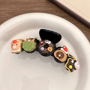Detail of black hair claw clip featuring 3D cartoon bear donuts and strawberry toast charms