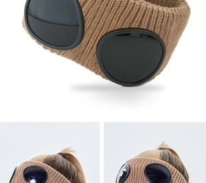 Detail of khaki chunky knit headband featuring integrated dark goggle lenses decoration