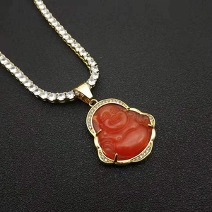 Detail of gold-plated hip-hop chain with red opal Buddha pendant and zircon inlay