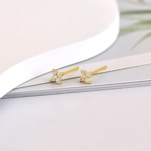 Macro shot of S925 sterling silver stamp on golden clover earring with micro-set zircon