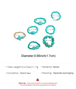 Detail view of 7-piece bohemian ring set with turquoise beads, pearls, and a cross charm