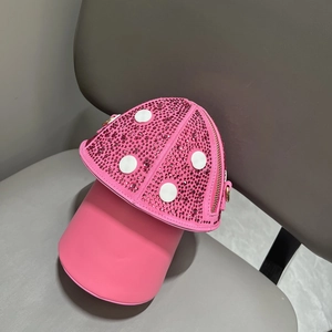 Detail of pink mushroom crossbody bag featuring sparkling rhinestones and white polka dots