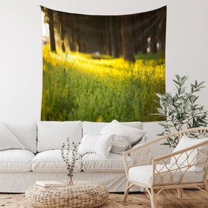 Detail view of Bohemian forest tapestry showing sunlit woodland scenery on living room wall