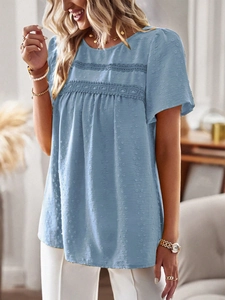 Detailed view of light blue Swiss dot fabric and lace patchwork on short sleeve top