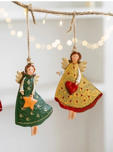 Detail of vintage iron Christmas angels with painted green and yellow star heart patterns