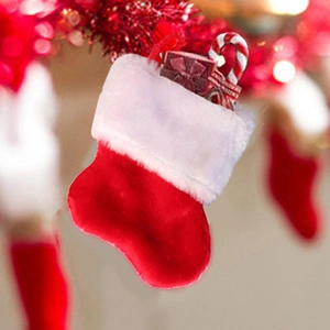 Close-up of a festive felt Christmas stocking with a candy cane and gift box decor