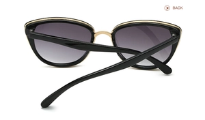 Back view of oversized butterfly sunglasses with gold metal trim and gradient grey lenses