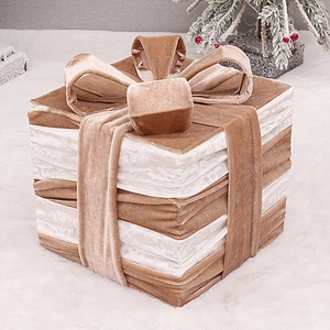 Detail of champagne and pink striped velvet Christmas gift box with decorative bow