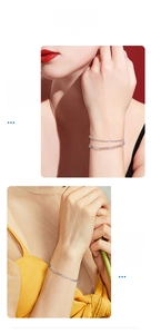 Double-layered S925 silver paperclip bracelet with a sparkling chain on a model's wrist