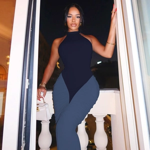 Detail of sexy backless halter top and navy pleated pants for a chic evening party look