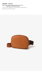 Close-up of brown nylon waist bag featuring black buckle strap and durable metal zippers