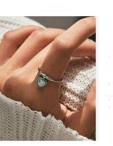 Detail of S925 sterling silver ring with mint green enamel and heart zircon pendant