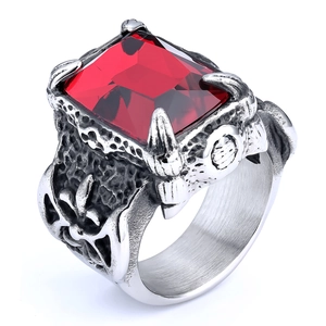 Macro shot of vintage silver ring with square red gemstone and ornate side carvings