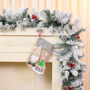 Detail of burlap Christmas stocking featuring a 3D gnome doll and festive embroidery