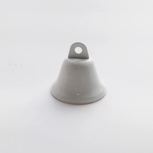 Close-up of a white polished metal bell with hanging loop for Christmas decoration