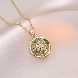 Elegant rotating flower necklace in gold stainless steel with green and white gems