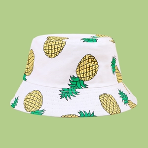 Close-up of the breathable cotton twill fabric with vibrant yellow pineapple print pattern