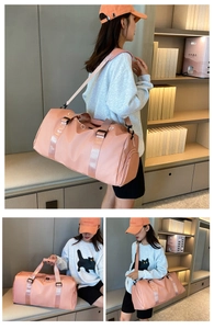 Pink waterproof nylon gym bag featuring separate wet-dry compartment and shoulder strap