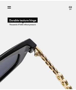 Detailed macro view of durable golden metal chain hinge on black cat-eye sunglasses