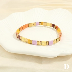 Detail of colorful Tila beaded bracelet in vintage bohemian style on shell dish