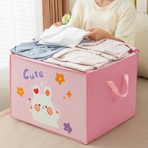 Detailed view of pink cartoon rabbit storage bag being filled with folded clothes