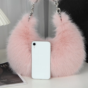 Pink plush shoulder bag with silver chain and a phone for size reference comparison