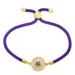 Detail of purple braided bracelet featuring a gold star pendant with micro-set zircons